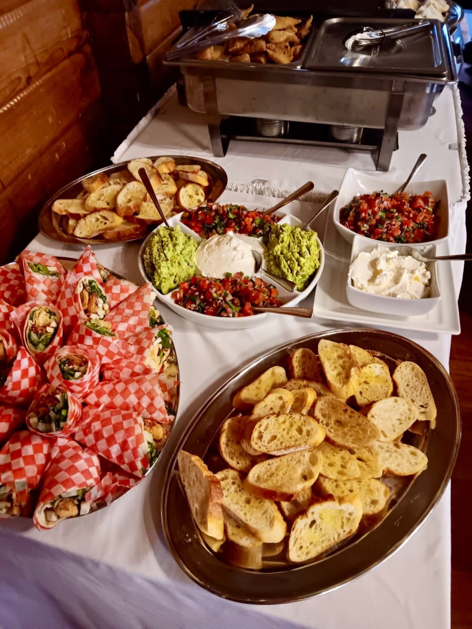 An array of hors d’oeuvres and breads on a buffet table