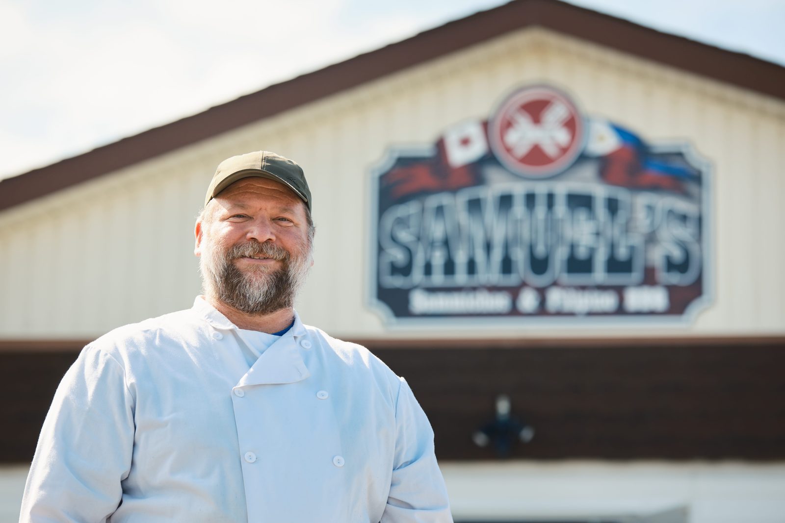 Rob outside the shop in his chef whites