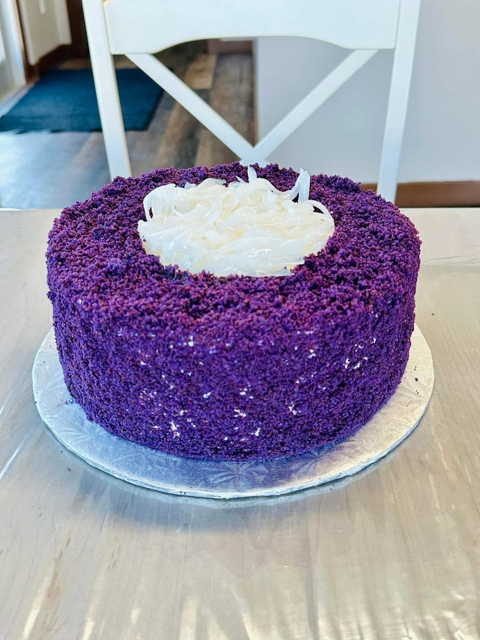 Cristina's signature ube cake, covered in purple yam crumb with coconut