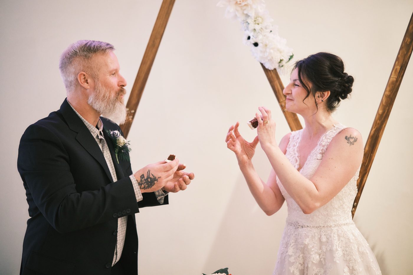 Bride and groom sharing a slice of their wedding cake